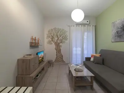 a living room with a tree mural on the wall at Cozy Athenian One BD, Pistachio Charm in Athens