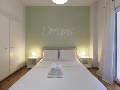 a bedroom with a bed with white shoes on it at Cozy Athenian One BD, Pistachio Charm in Athens