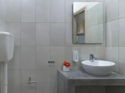 a white bathroom with a sink and a mirror at Cozy Athenian One BD, Pistachio Charm in Athens