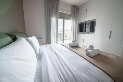 a bedroom with a bed with two pillows on it at Modern 7th-floor apartment with city view (FORM_G2) in Athens
