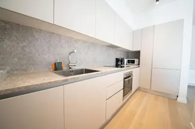 a kitchen with white cabinets and a sink at Modern 7th-floor apartment with city view (FORM_G2) in Athens