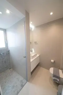 a white bathroom with a sink and a toilet at Modern 7th-floor apartment with city view (FORM_G2) in Athens