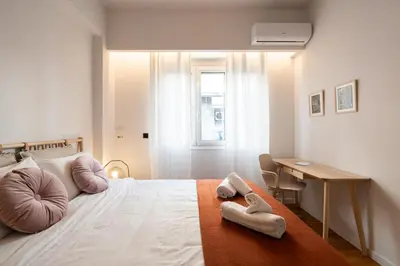 a bedroom with a bed with two towels on it at LIV - Modern Heavenly Retreat in Exarcheia in Athens