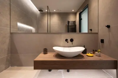 a bathroom with a large white bowl sink on a wooden counter at LIV - Modern Heavenly Retreat in Exarcheia in Athens