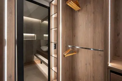 a bathroom with wooden walls and a glass door at LIV - Modern Heavenly Retreat in Exarcheia in Athens