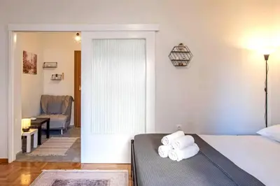 a bedroom with a bed with towels on it at Minimal and cozy Home in Zografou in Athens