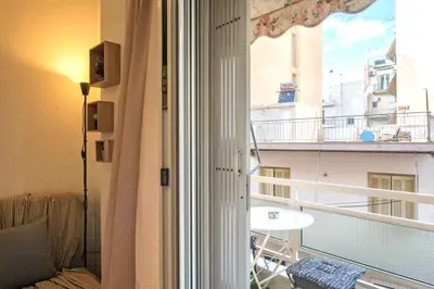 a room with a window with a view of a balcony at Minimal and cozy Home in Zografou in Athens