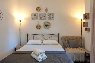a bedroom with a bed with towels on it at Minimal and cozy Home in Zografou in Athens