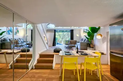 a dining room with a table and yellow chairs at The Four Seasons Vouliagmeni Escape in Athens