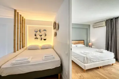 a bedroom with two beds and a mirror at The Four Seasons Vouliagmeni Escape in Athens
