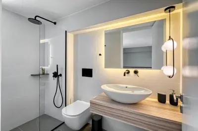 a bathroom with a sink and a toilet and a mirror at The Four Seasons Vouliagmeni Escape in Athens