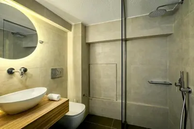 a bathroom with a sink and a shower at The Four Seasons Vouliagmeni Escape in Athens