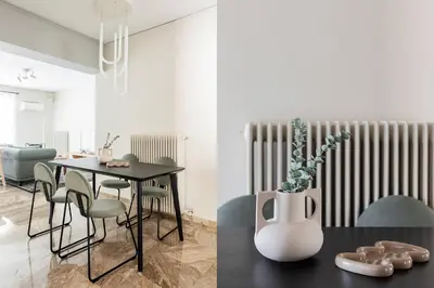 a dining room with a table and a vase with a plant at Exclusive 2BR Apartment in Alimos by UPSTREET in Athens