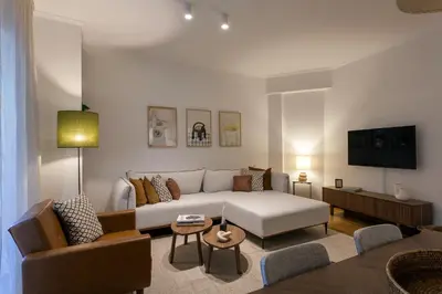 a living room with a couch and a tv at Heart of Athens - Hidden Gem - Elegant 2 Bedroom Flat in Athens