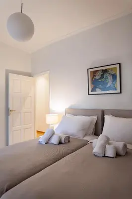 a bedroom with a bed with two pillows on it at Heart of Athens - Hidden Gem - Elegant 2 Bedroom Flat in Athens