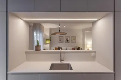 a kitchen with a sink in front of a mirror at Heart of Athens - Hidden Gem - Elegant 2 Bedroom Flat in Athens
