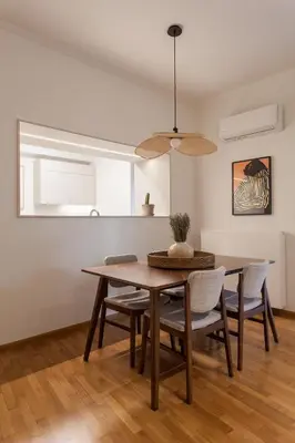 a dining room with a table and chairs at Heart of Athens - Hidden Gem - Elegant 2 Bedroom Flat in Athens