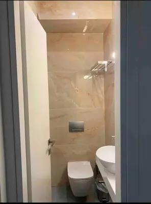a small bathroom with a toilet and a sink at 130m Luxury apartment in the heart of Athens in Athens