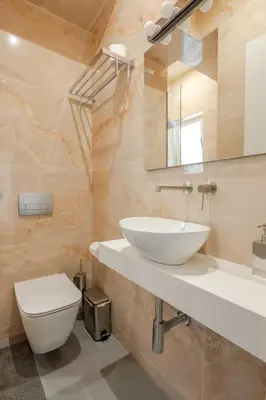 a bathroom with a sink and a toilet at 130m Luxury apartment in the heart of Athens in Athens