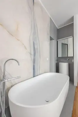 a bathroom with a white tub and a sink at 130m Luxury apartment in the heart of Athens in Athens