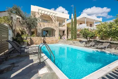 a swimming pool in front of a house at Διαμέρισμα με πισίνα στην Αρτέμιδα in Vravrona