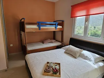 a bedroom with two bunk beds with a tray on the bed at Zoe's home - stunning view in Áyios Konstandínos