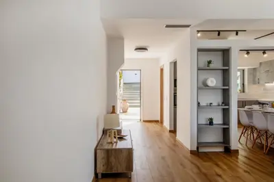 a living room with a table and a kitchen at Astarte Sunset Villa in Sounio
