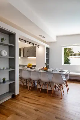 a kitchen and dining room with a table and chairs at Astarte Sunset Villa in Sounio