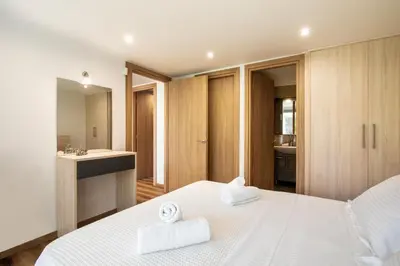 a bedroom with a white bed with two towels on it at Astarte Sunset Villa in Sounio