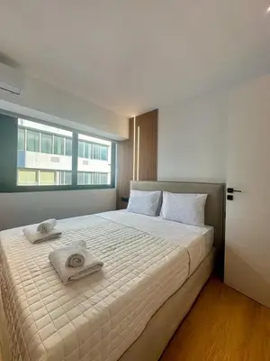 a bedroom with a large bed with towels on it at BlueMotion -PortStay N1 in Piraeus