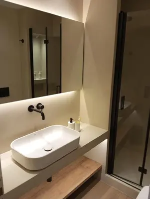 a bathroom with a white sink and a mirror at BlueMotion -PortStay N1 in Piraeus