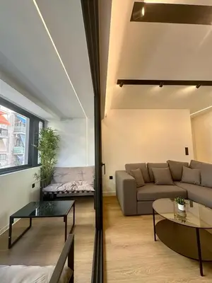 a living room with a couch and a table at BlueMotion -PortStay N1 in Piraeus