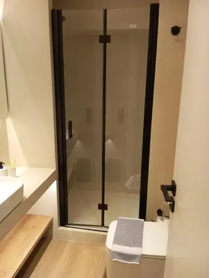 a bathroom with a shower and a toilet at BlueMotion -PortStay N1 in Piraeus