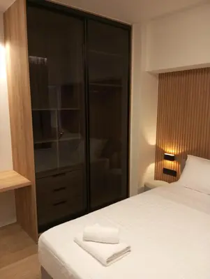a bedroom with a bed and a glass closet at BlueMotion -PortStay N1 in Piraeus