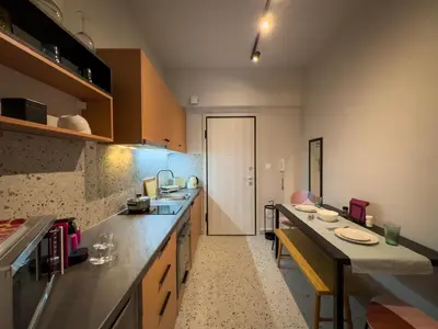 a kitchen with a long counter and a hallway at Luxury Studio with Panoramic Views in Athens