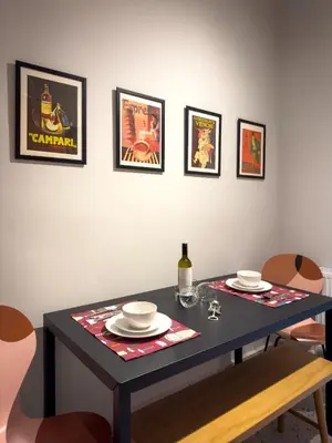 a dining room table with plates and a bottle of wine at Luxury Studio with Panoramic Views in Athens