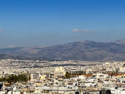 a view of a city with mountains in the background at Luxury Studio with Panoramic Views in Athens