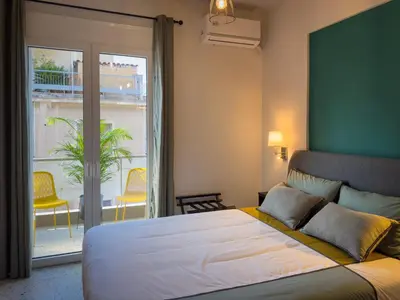 a bedroom with a large bed and a balcony at Luxury Studio with Panoramic Views in Athens