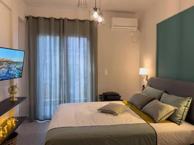 a bedroom with a large bed and a television at Luxury Studio with Panoramic Views in Athens