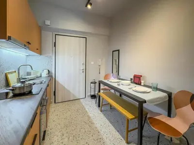 a kitchen with a table and chairs in a room at Luxury Studio with Panoramic Views in Athens