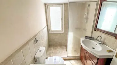a bathroom with a white toilet and a sink at Alimos Sea View Family Apartment in Athens
