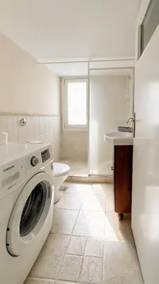 a washing machine in a bathroom with a toilet at Alimos Sea View Family Apartment in Athens