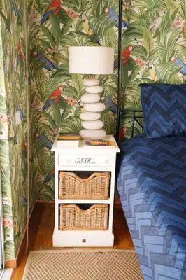 a lamp on a night stand next to a bed at Dreamy relaxing secluded Villa Aurora in Palaiá Fókaia