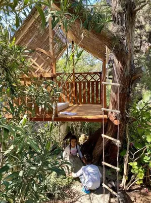 two children are sitting in a tree house at Dreamy relaxing secluded Villa Aurora in Palaiá Fókaia