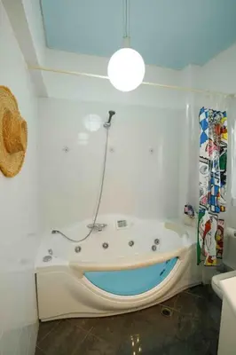 a bathroom with a bath tub in the corner at Dreamy relaxing secluded Villa Aurora in Palaiá Fókaia
