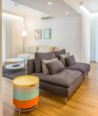 a living room with a couch and a table at Elegance Vouliagmeni Gem Luxury Apt, Walk to Beach in Athens
