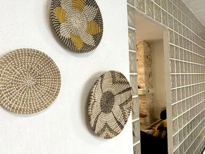 three plates are hanging on a wall at Glyfada Grand Residence in Athens