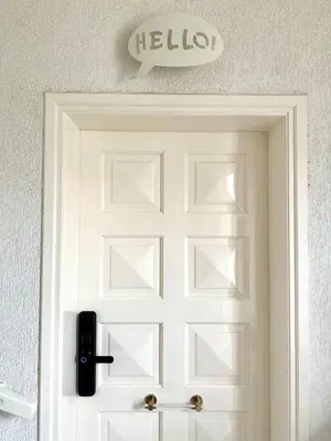 a white door with a hello sign above it at Glyfada Grand Residence in Athens