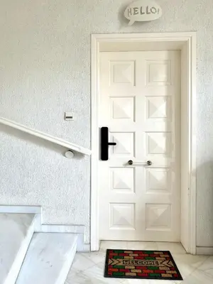a white door with a rug in front of it at Glyfada Grand Residence in Athens