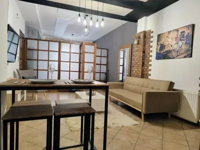 a living room with a table and a couch at Page55 in Piraeus